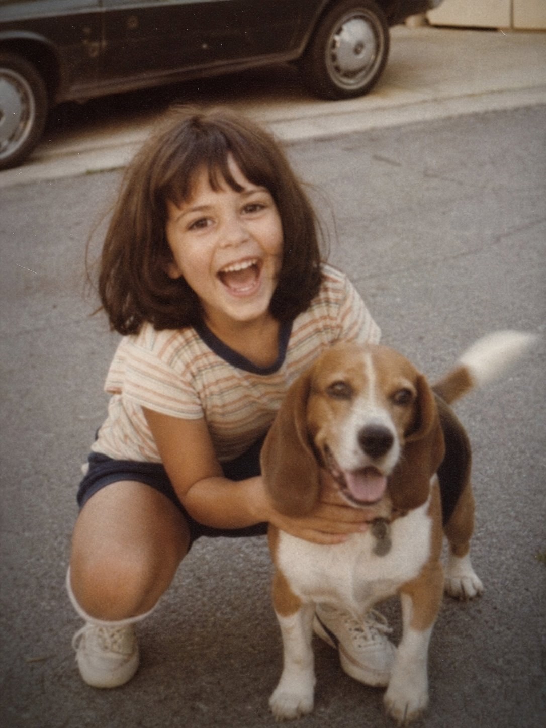 Ms. Katy as a child with her family's beagle Roy